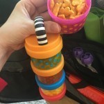 A Stack-able Snack Cylinder - Fill compartment filled with different treats ranging from blueberries, to cheddar bunnies for variety.